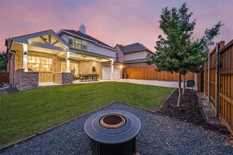 a view of a big house with a big yard and potted plants
