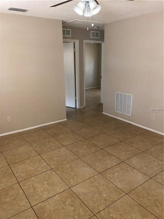 2278 19th Avenue Southwest Largo, FL 33774 - Photo 11 of 11 an empty room with water heater and hallway view