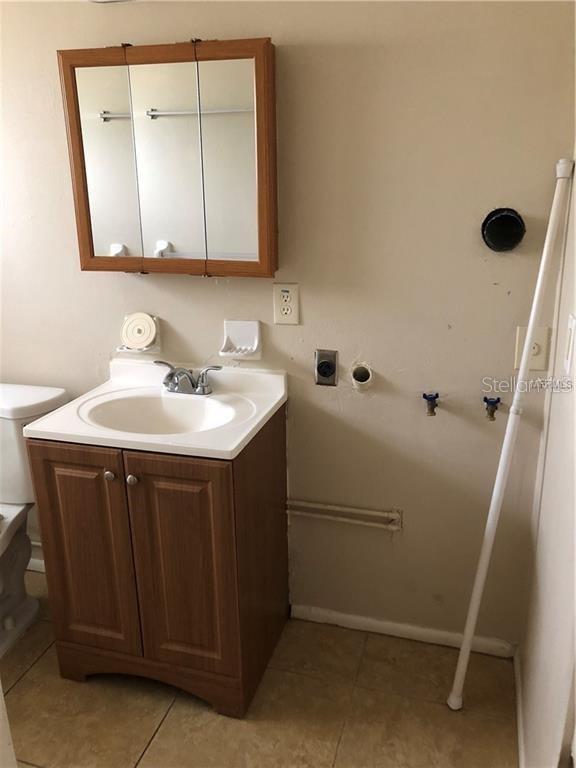 2278 19th Avenue Southwest Largo, FL 33774 - Photo 4 of 11 a bathroom with a sink vanity and mirror