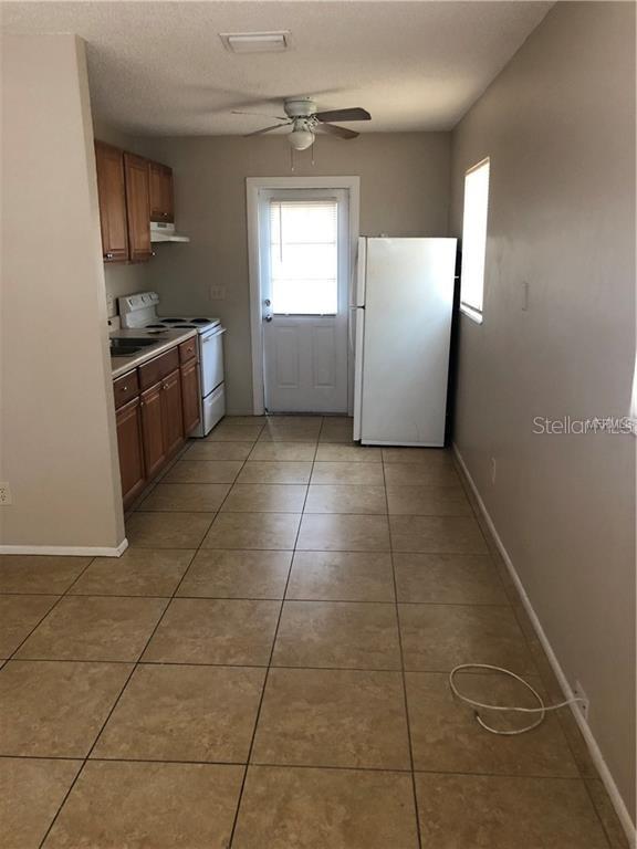 2278 19th Avenue Southwest Largo, FL 33774 - Photo 8 of 11 a kitchen with granite countertop a stove a sink and a refrigerator