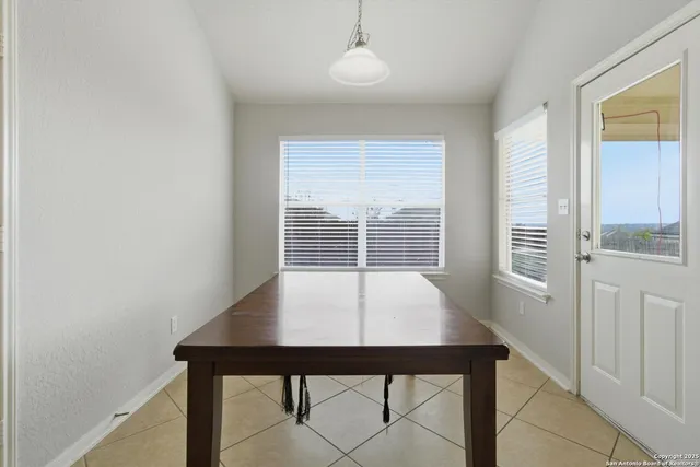 a view of a room with a table and chairs
