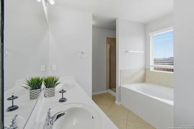 a bathroom with a tub sink and mirror