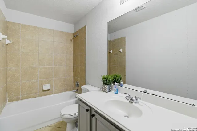 a bathroom with a sink toilet tub and shower