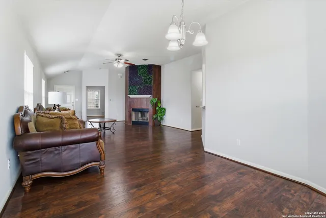a living room with furniture and a chandelier