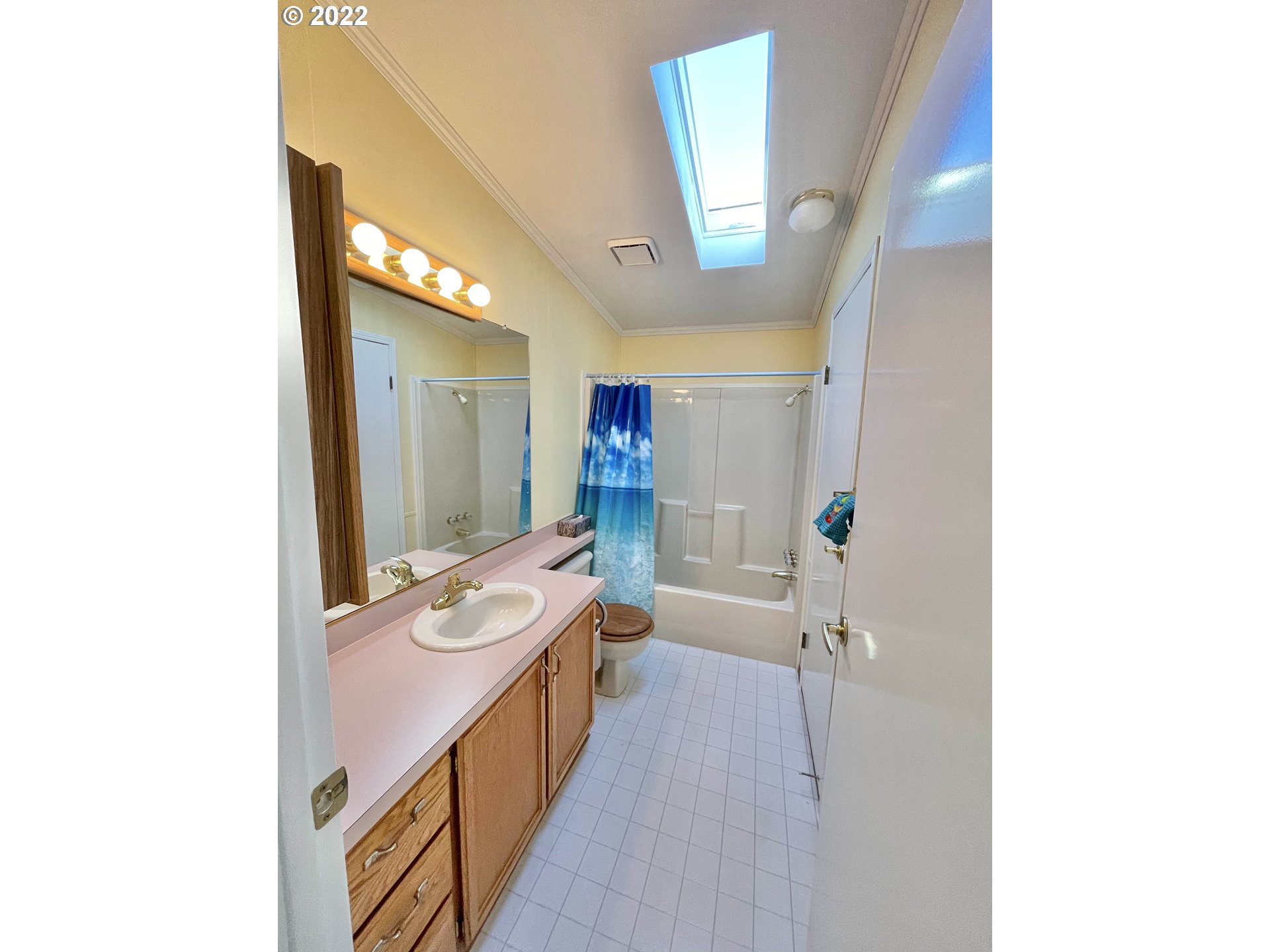 100 River Bend Road, Unit 101 Reedsport, OR 97467 - Photo 11 of 30 a bathroom with a sink a mirror and a bathtub