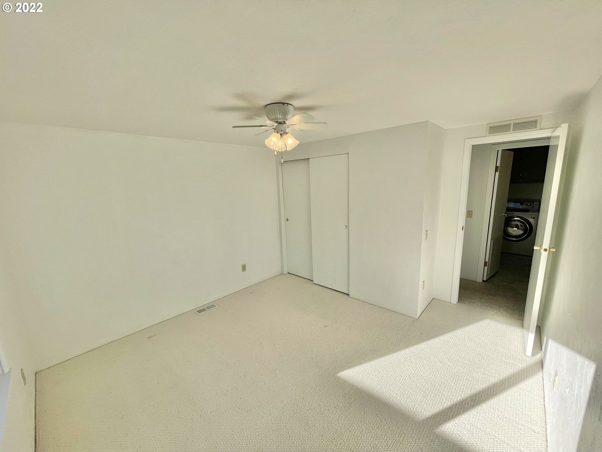 100 River Bend Road, Unit 101 Reedsport, OR 97467 - Photo 14 of 30 an empty room with a ceiling fan and a bathroom