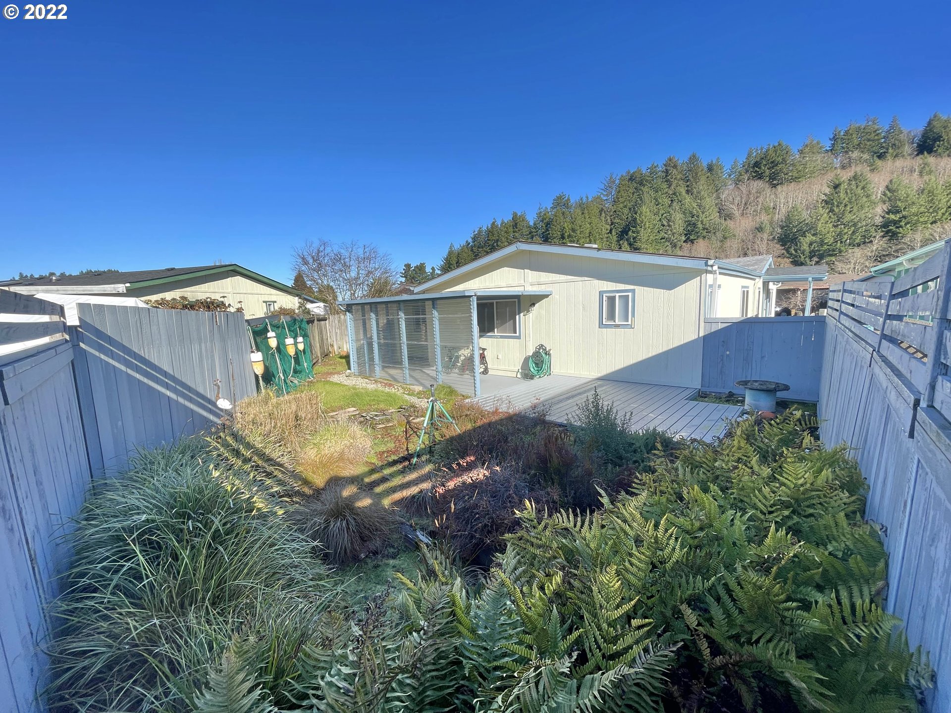 100 River Bend Road, Unit 101 Reedsport, OR 97467 - Photo 19 of 30 a view of a house with a yard and plants