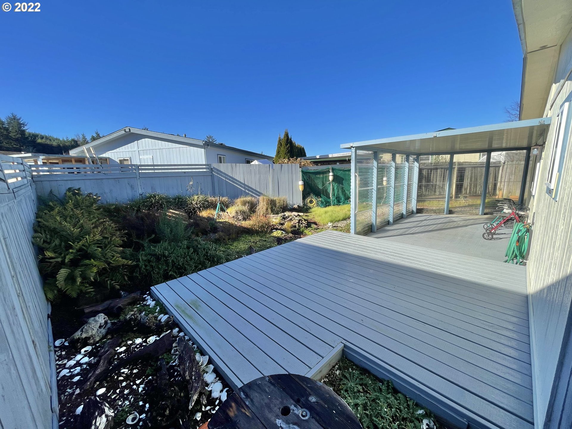 100 River Bend Road, Unit 101 Reedsport, OR 97467 - Photo 20 of 30 a view of a house with backyard and sitting area