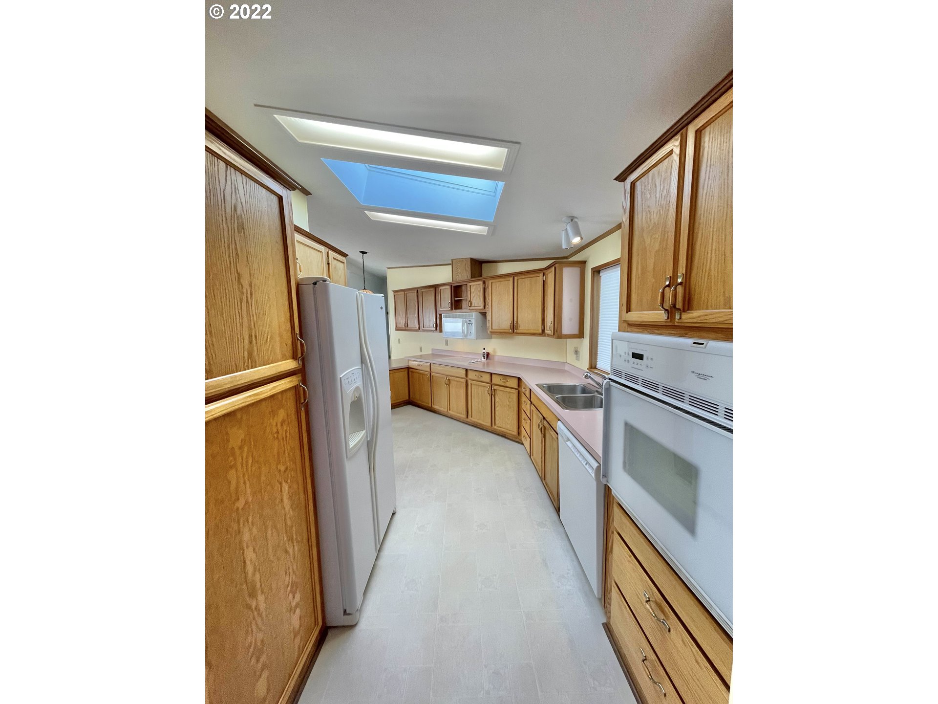 100 River Bend Road, Unit 101 Reedsport, OR 97467 - Photo 4 of 30 a kitchen with stainless steel appliances granite countertop a refrigerator and a stove