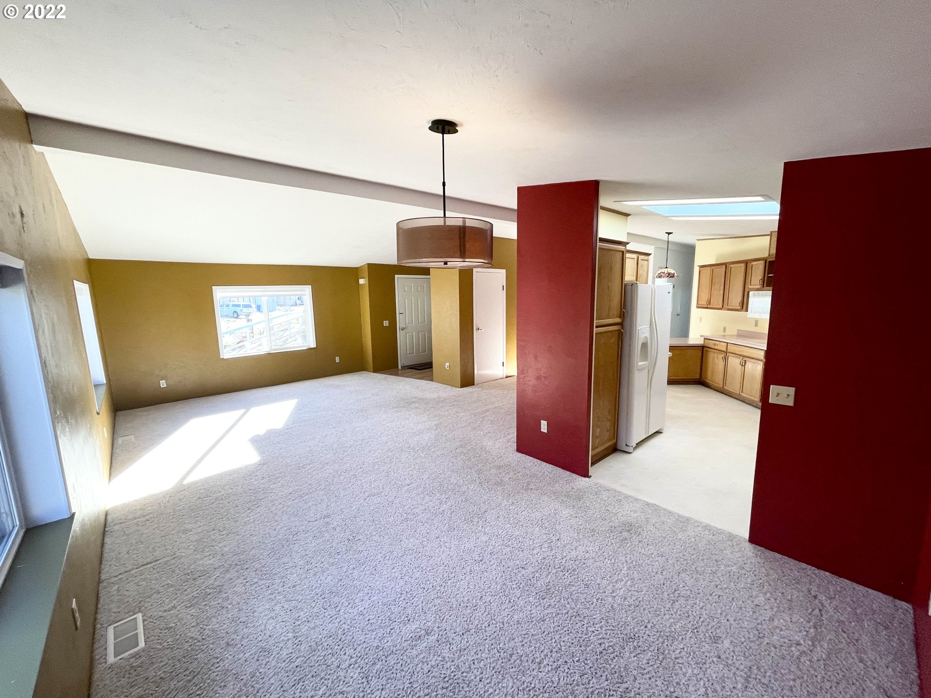 100 River Bend Road, Unit 101 Reedsport, OR 97467 - Photo 5 of 30 a view of a kitchen with a refrigerator a ceiling fan and a refrigerator