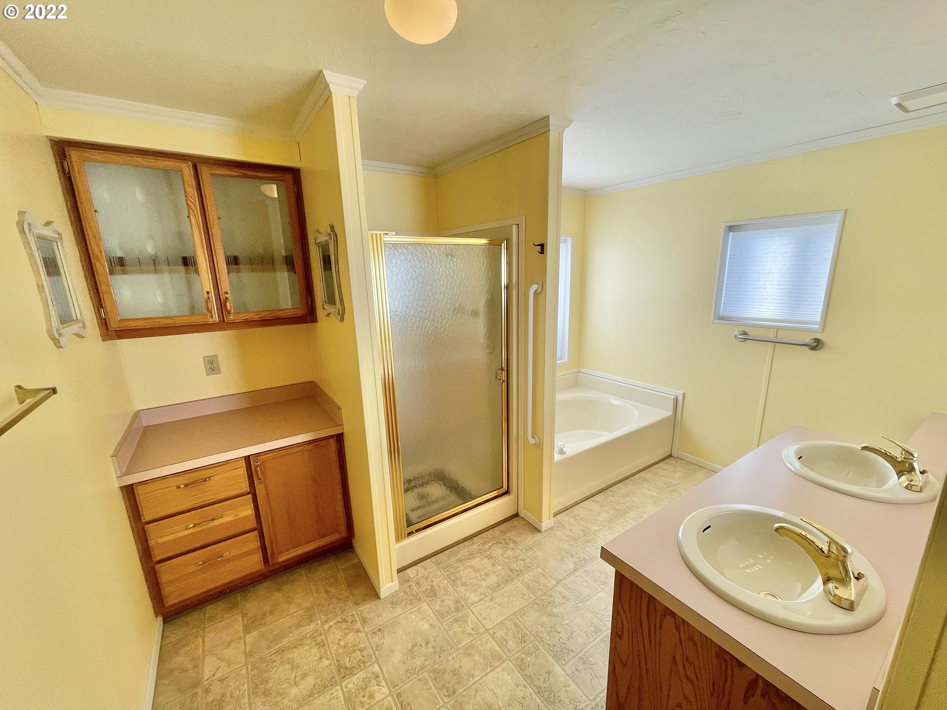 100 River Bend Road, Unit 101 Reedsport, OR 97467 - Photo 9 of 30 a bathroom with a sink a mirror and a shower