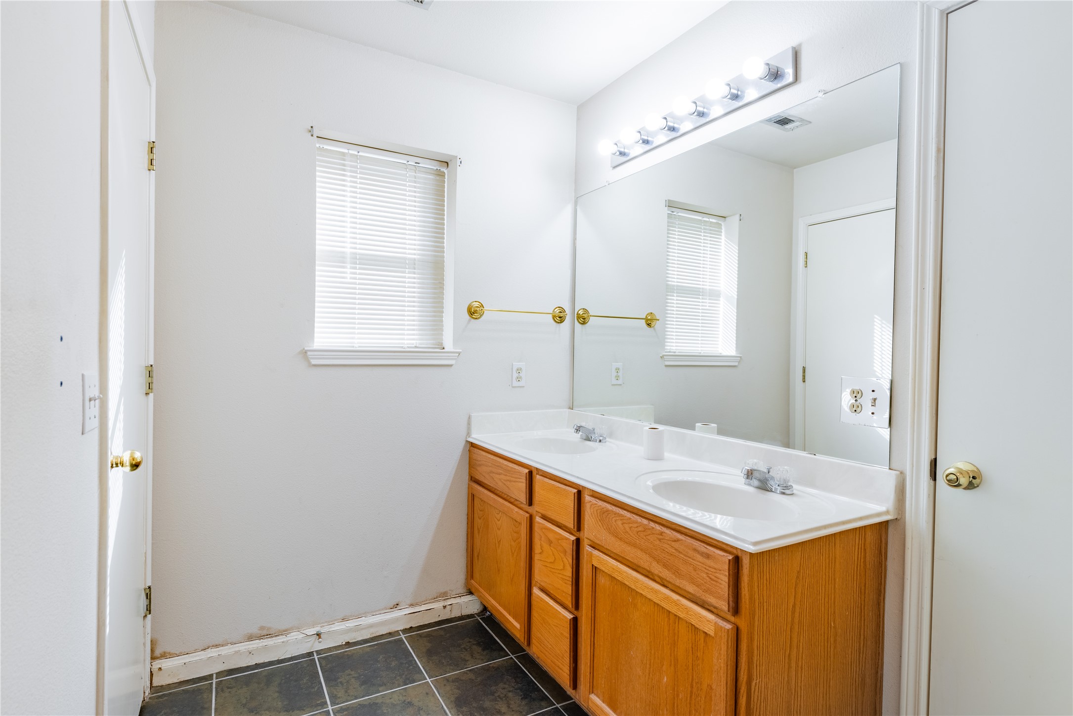 600 Tobin Drive Buda, TX 78610 - Photo 10 of 21 Full bath with double vanity and dark tile patterned floors