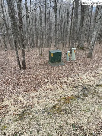 a backyard of a house with chairs and wooden fence