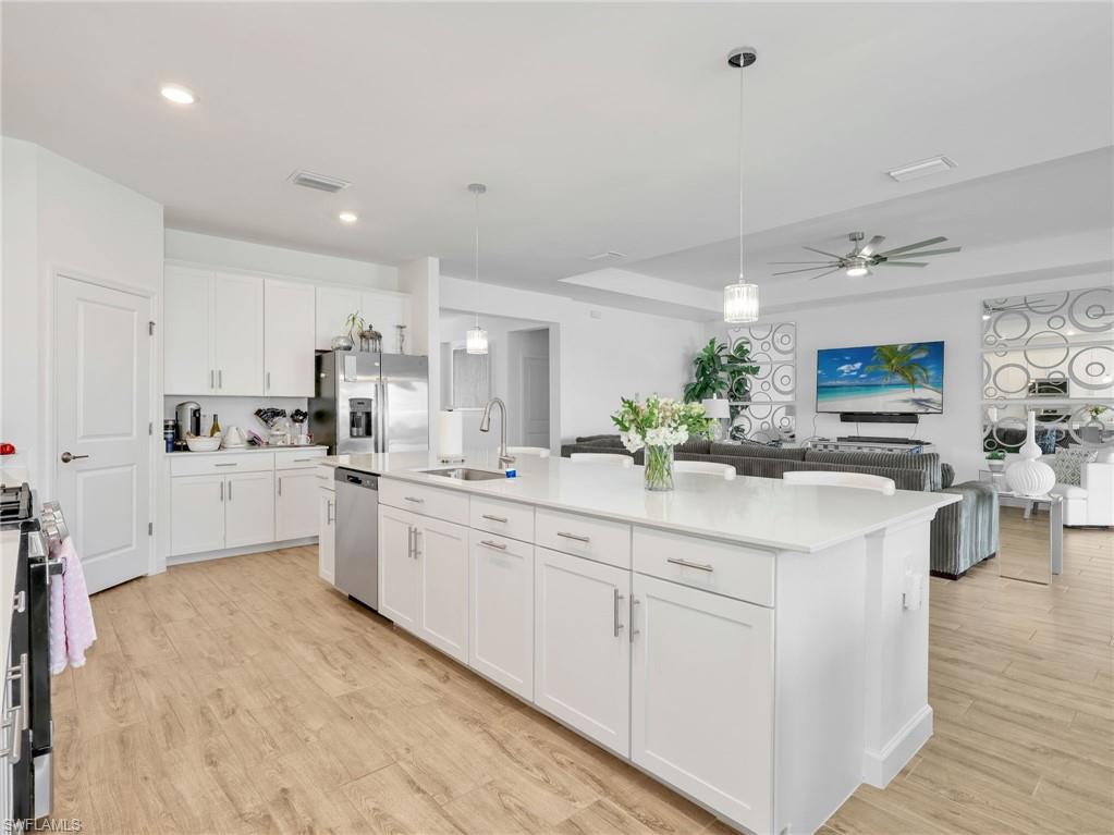18278 Ridgeline Drive Estero, FL 33928 - Photo 9 of 45 a kitchen with white cabinets and sink