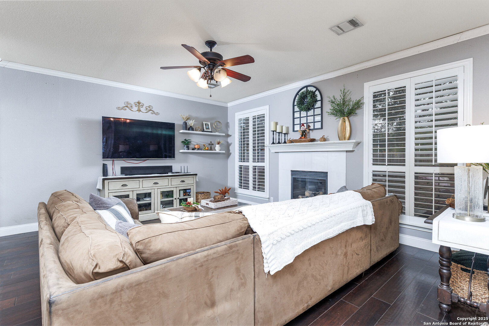 9026 Colfax Helotes, TX 78023 - Photo 15 of 40 a living room with furniture a fireplace and a flat screen tv