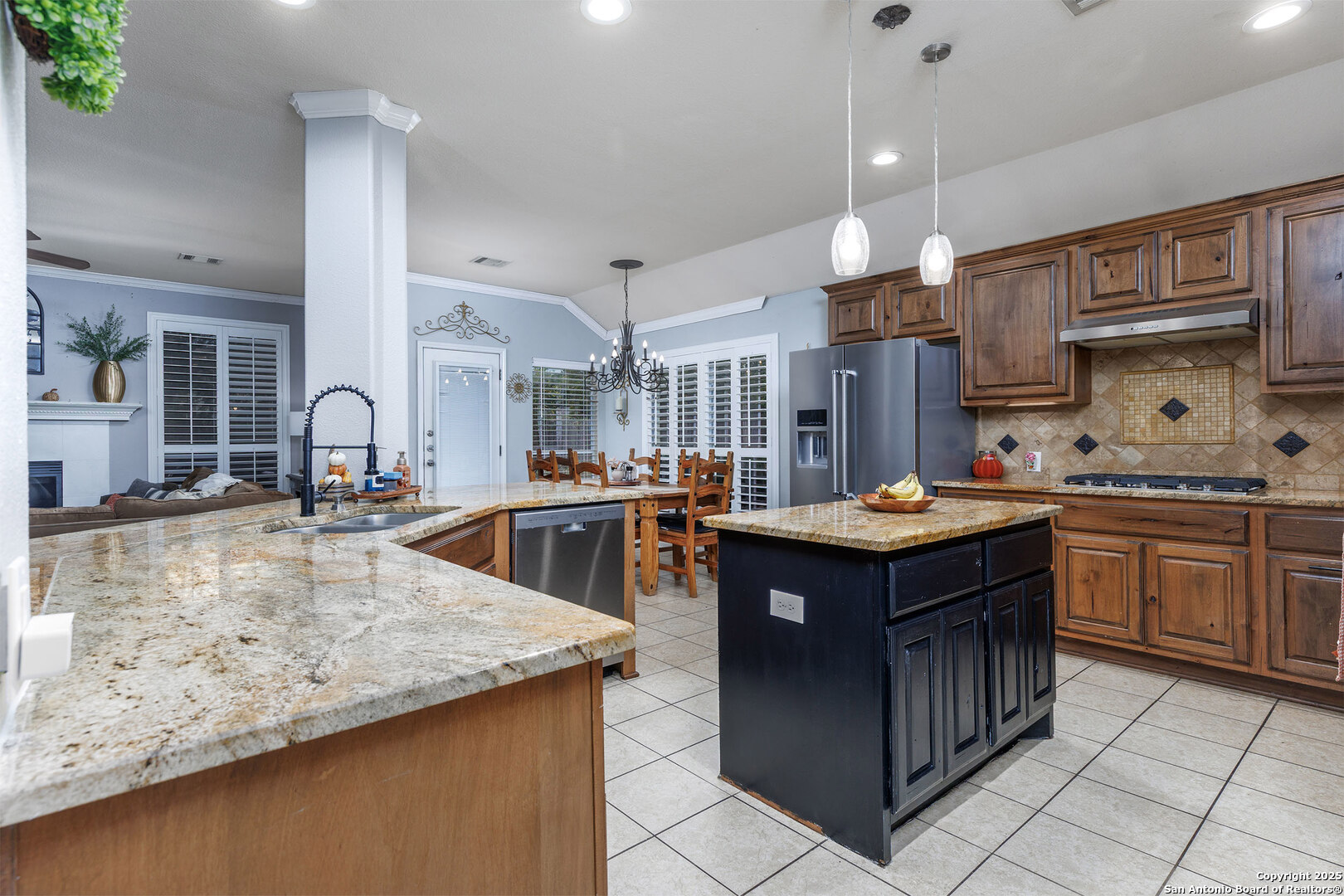 9026 Colfax Helotes, TX 78023 - Photo 16 of 40 a kitchen with granite countertop a sink counter top space and stainless steel appliances