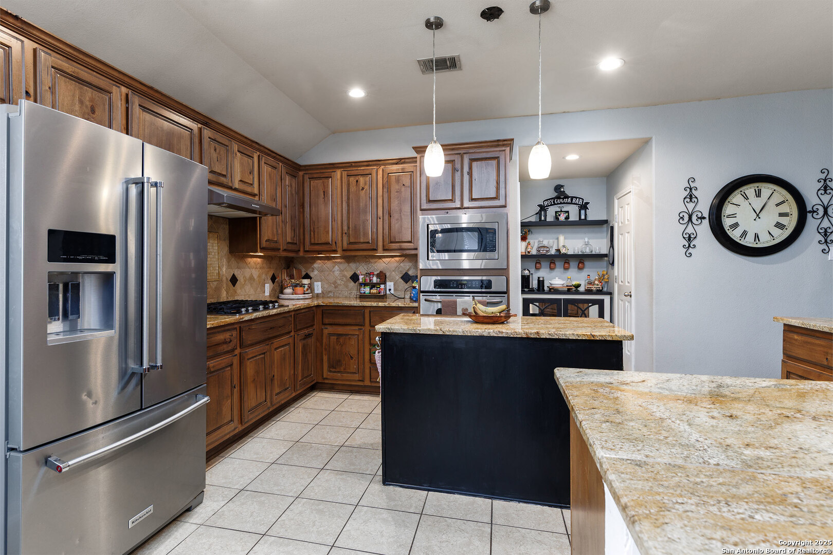 9026 Colfax Helotes, TX 78023 - Photo 17 of 40 a kitchen with stainless steel appliances granite countertop a refrigerator a stove a sink and a refrigerator