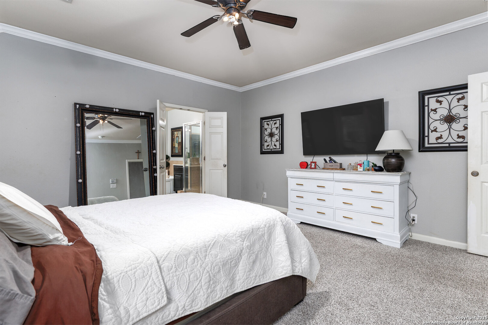 9026 Colfax Helotes, TX 78023 - Photo 28 of 40 a bedroom with a bed and a flat screen tv