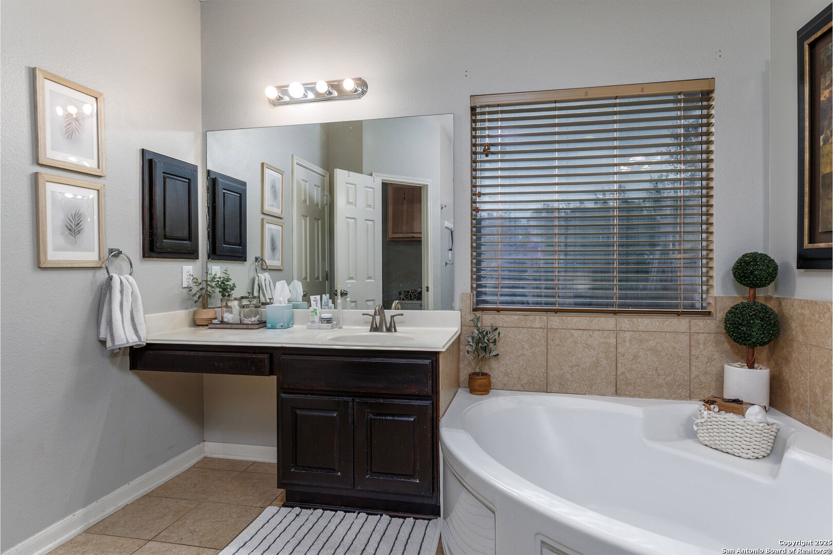 9026 Colfax Helotes, TX 78023 - Photo 29 of 40 a bathroom with a sink and a mirror