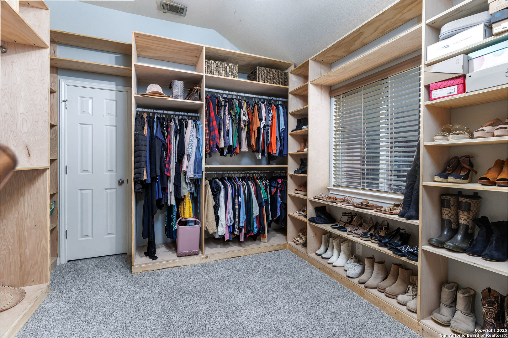 9026 Colfax Helotes, TX 78023 - Photo 31 of 40 a view of walk in closet with clothes and shoes