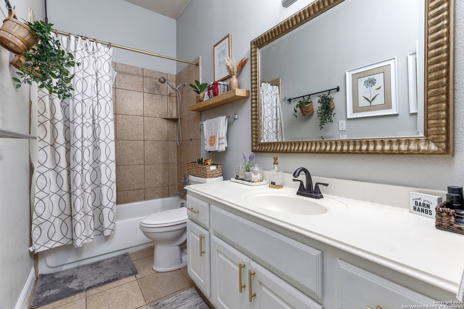 9026 Colfax Helotes, TX 78023 - Photo 33 of 40 a bathroom with a sink a toilet and shower curtain