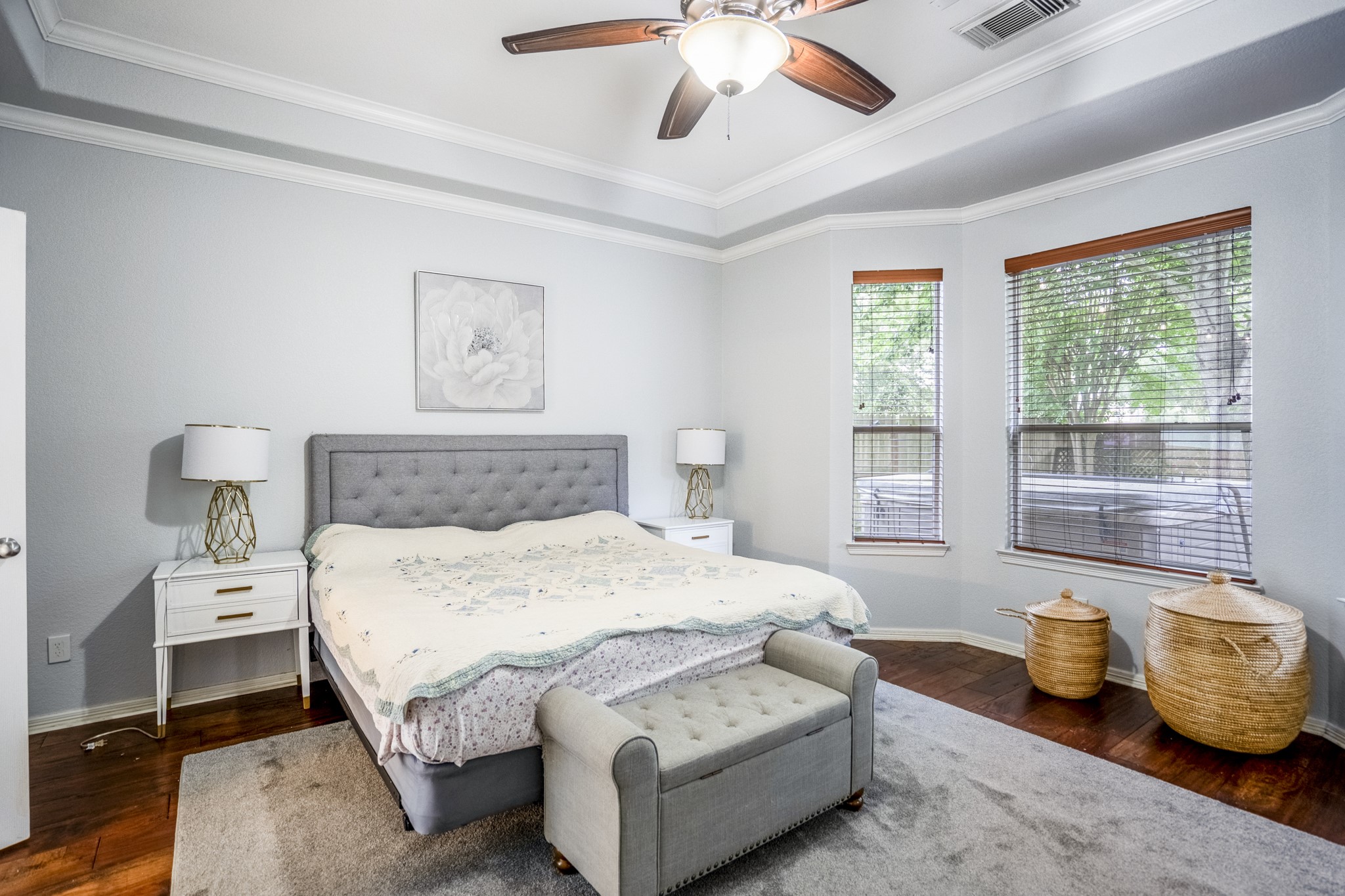 10410 Pitcataway Drive Spring, TX 77379 - Photo 17 of 48 The primary bedroom features a trey ceiling with crown moldings, the hand scaped wood floors, fabulous views of the backyard and dual doors to the en-suite.