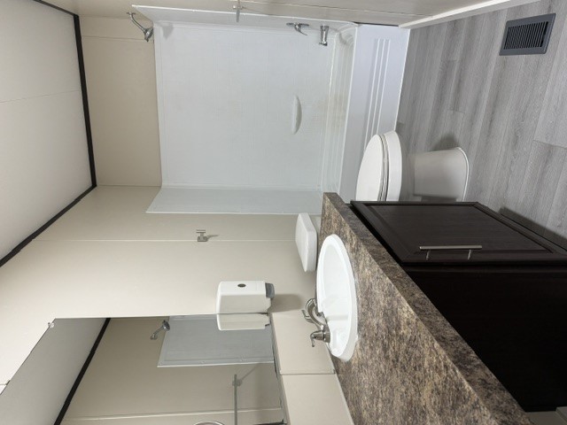 393 Duchess Pass Kyle, TX 78640 - Photo 10 of 14 This bathroom features a contemporary vanity with a spacious countertop and sleek cabinetry.