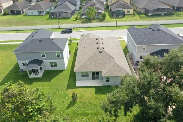 an aerial view of a house with a garden and a yard