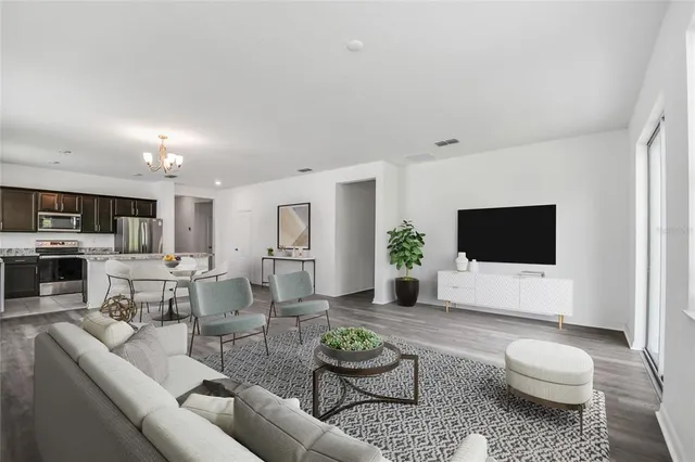 a living room with furniture a rug and a flat screen tv