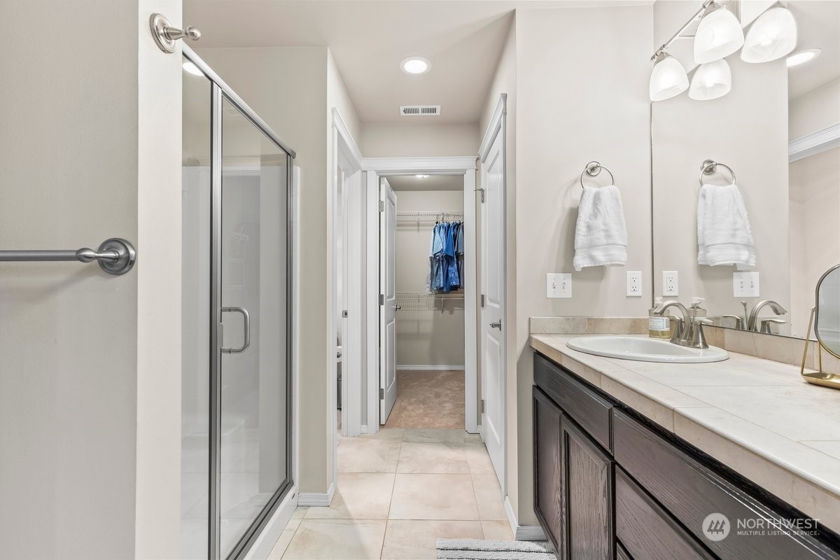 19005 Grannis Road Bothell, WA 98012 - Photo 16 of 31 a bathroom with a double vanity sink mirror and shower