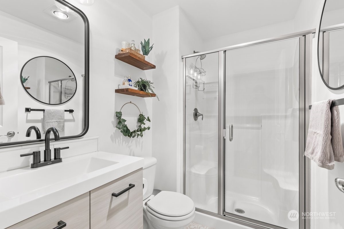 19005 Grannis Road Bothell, WA 98012 - Photo 5 of 31 a bathroom with a sink a toilet and a mirror