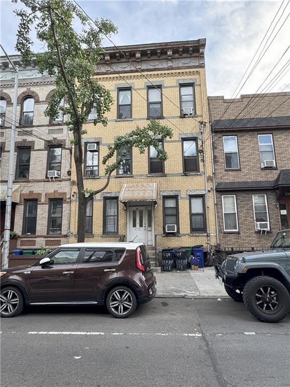 a car parked in front of a big house