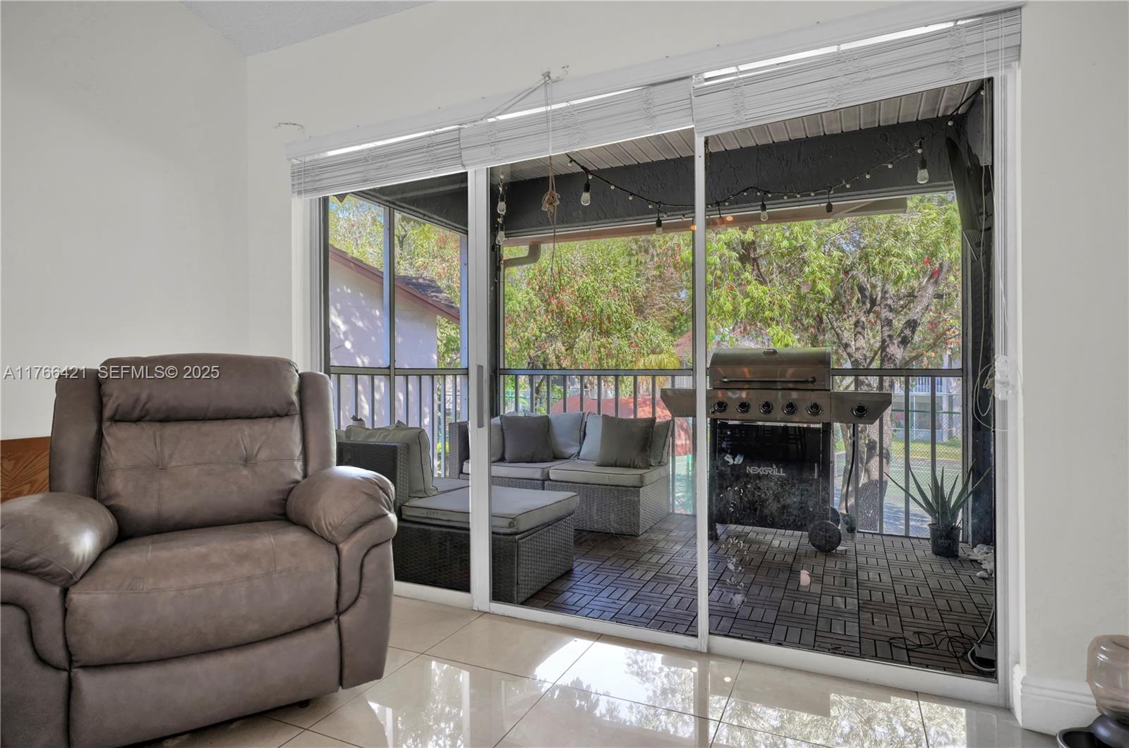 9503 Southwest 140th Court, Unit 9503 Miami, FL 33186 - Photo 11 of 32 a living room with furniture and a floor to ceiling window