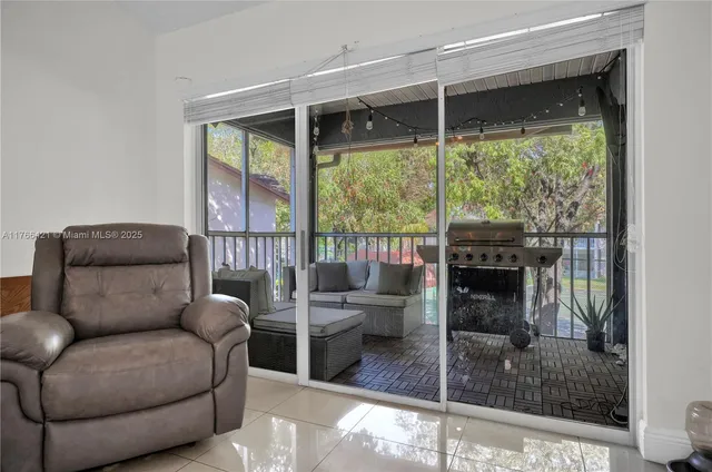 a living room with furniture and a floor to ceiling window