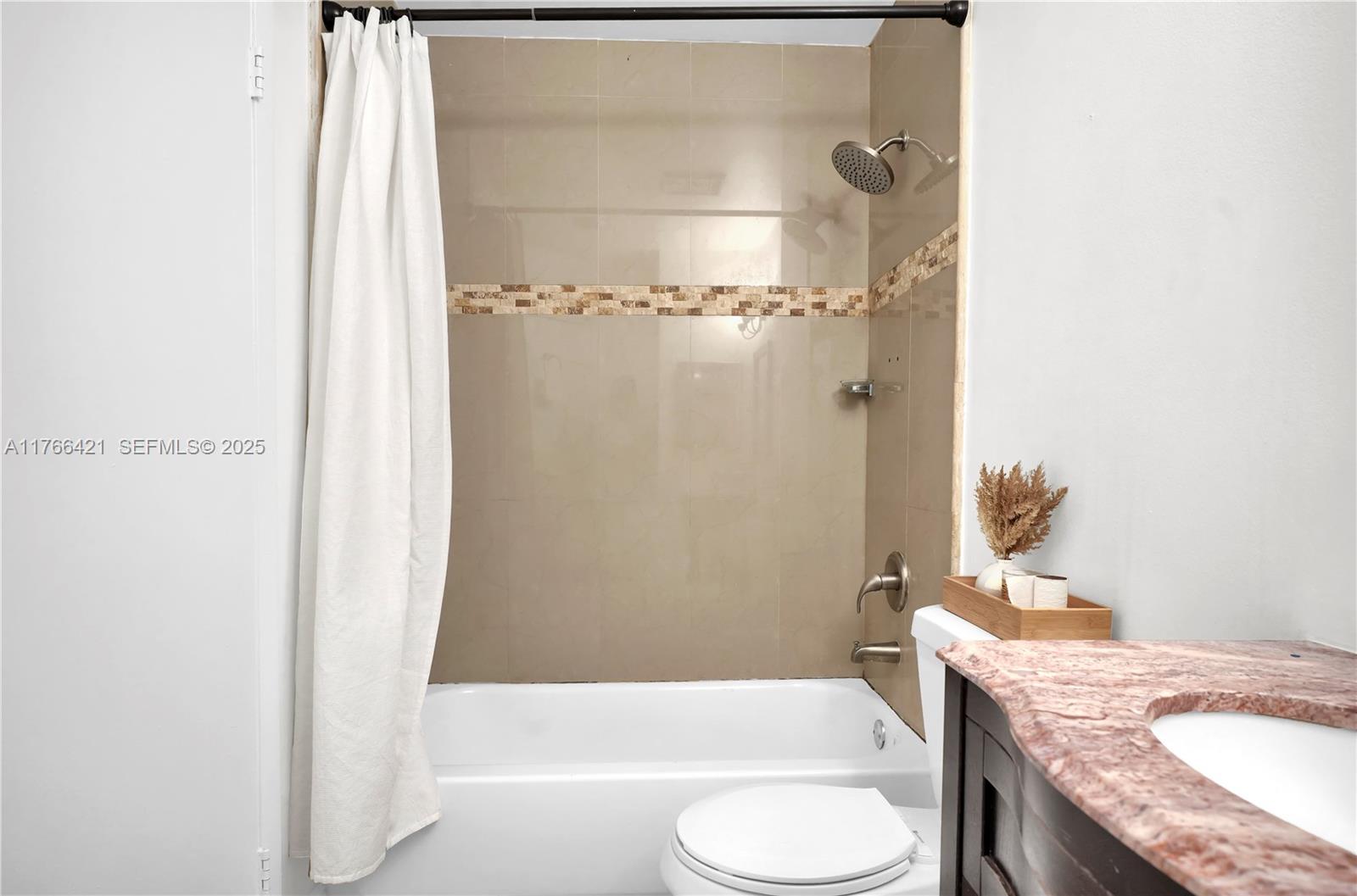 9503 Southwest 140th Court, Unit 9503 Miami, FL 33186 - Photo 19 of 32 a bathroom with a granite countertop sink toilet and shower