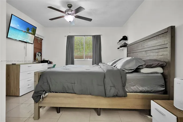 a bedroom with a bed and a painting on the wall