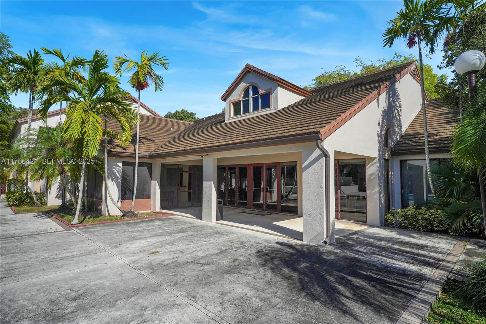 9503 Southwest 140th Court, Unit 9503 Miami, FL 33186 - Photo 30 of 32 a view of a house with small yard plants and palm trees