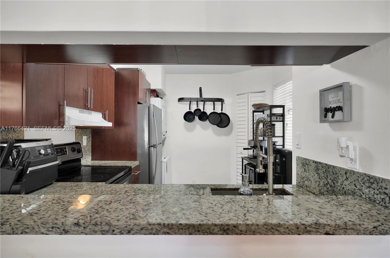 9503 Southwest 140th Court, Unit 9503 Miami, FL 33186 - Photo 5 of 32 a kitchen with a oven a refrigerator and a sink