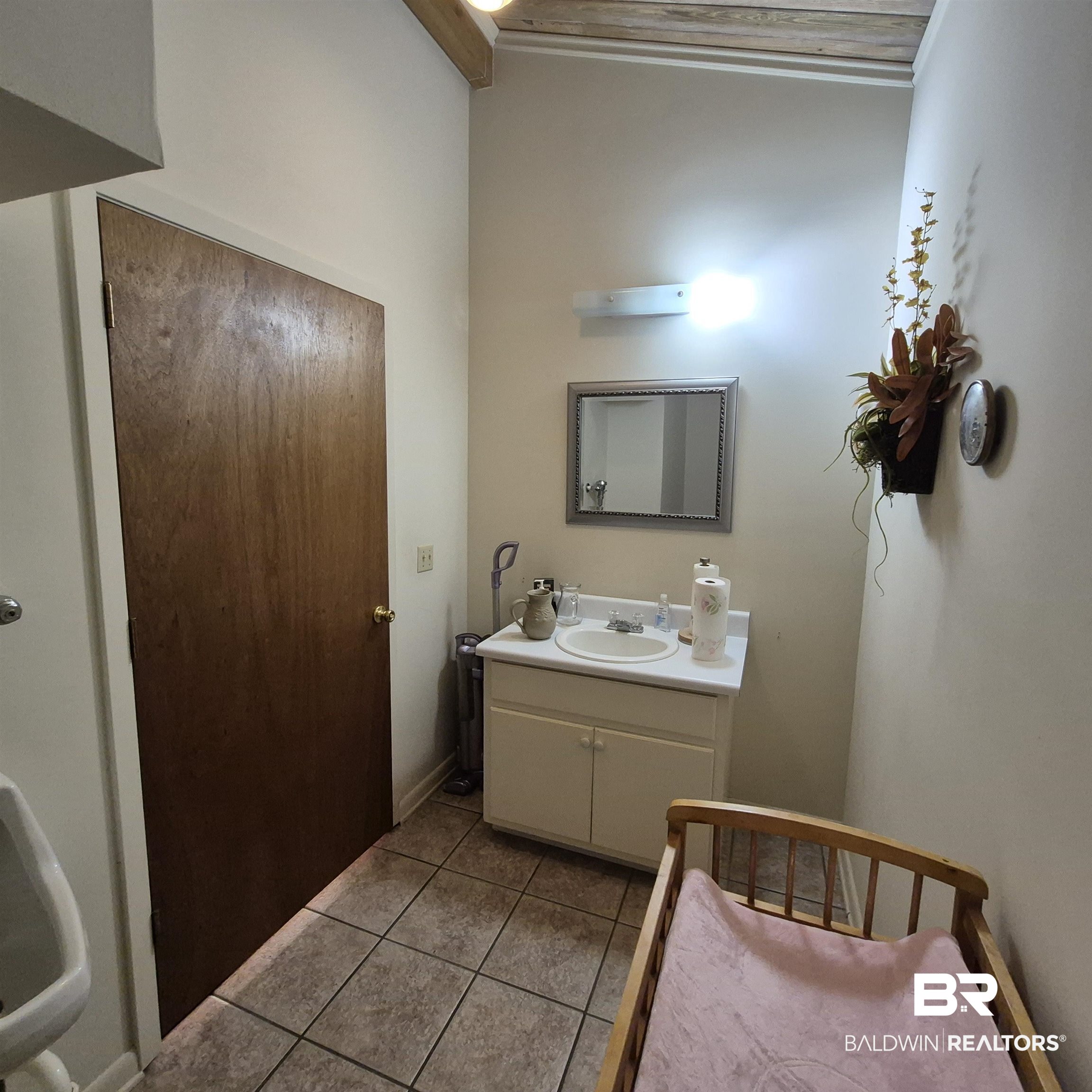 305 Rural Street Evergreen, AL 36401 - Photo 12 of 32 Bathroom featuring light tile patterned flooring, vanity, and lofted ceiling