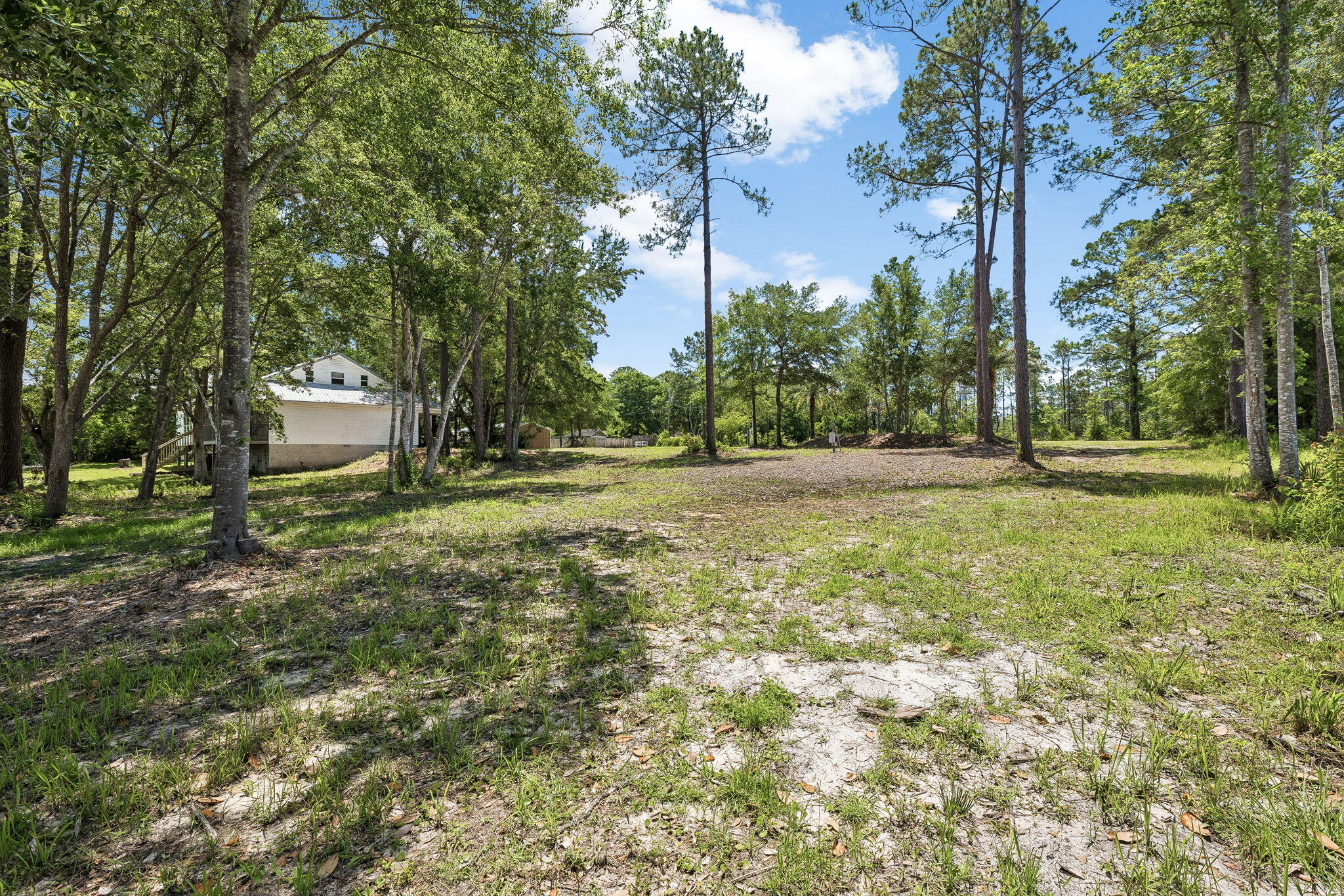 92 Waterside Lane Freeport, FL 32439 - Photo 21 of 28 a backyard of apartments with large trees