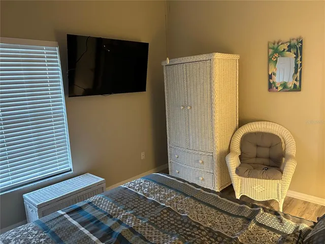 a bedroom with a bed and flat screen tv