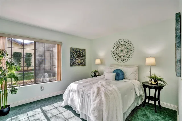 a bedroom with a large bed and a large window