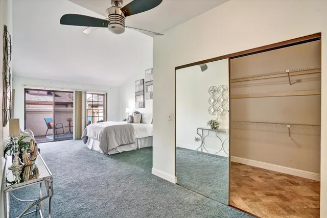 a spacious bedroom with a bed and a couch