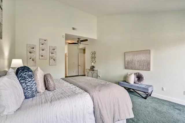 a bedroom with a bed and a lamp