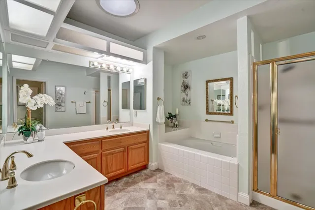 a bathroom with a tub sink and mirror