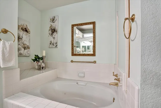 a white bath tub with a shower