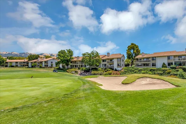 a view of a tennis ground with a lawn chairs