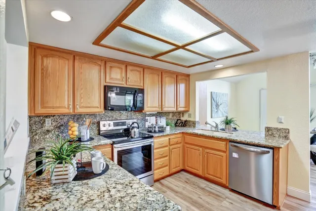 a kitchen with a sink stove and cabinets