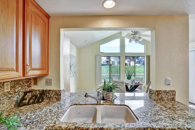 a kitchen with a sink and a large window