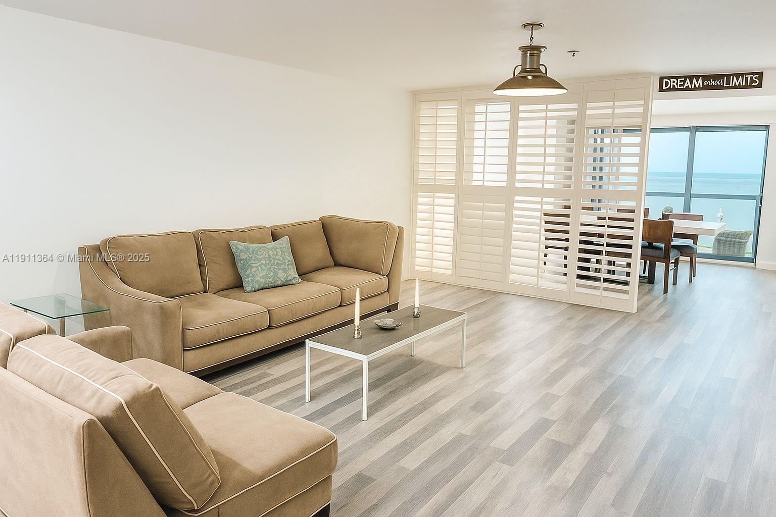 6345 Collins Avenue, Unit TH2 Miami Beach, FL 33141 - Photo 1 of 8 a living room with furniture and a window